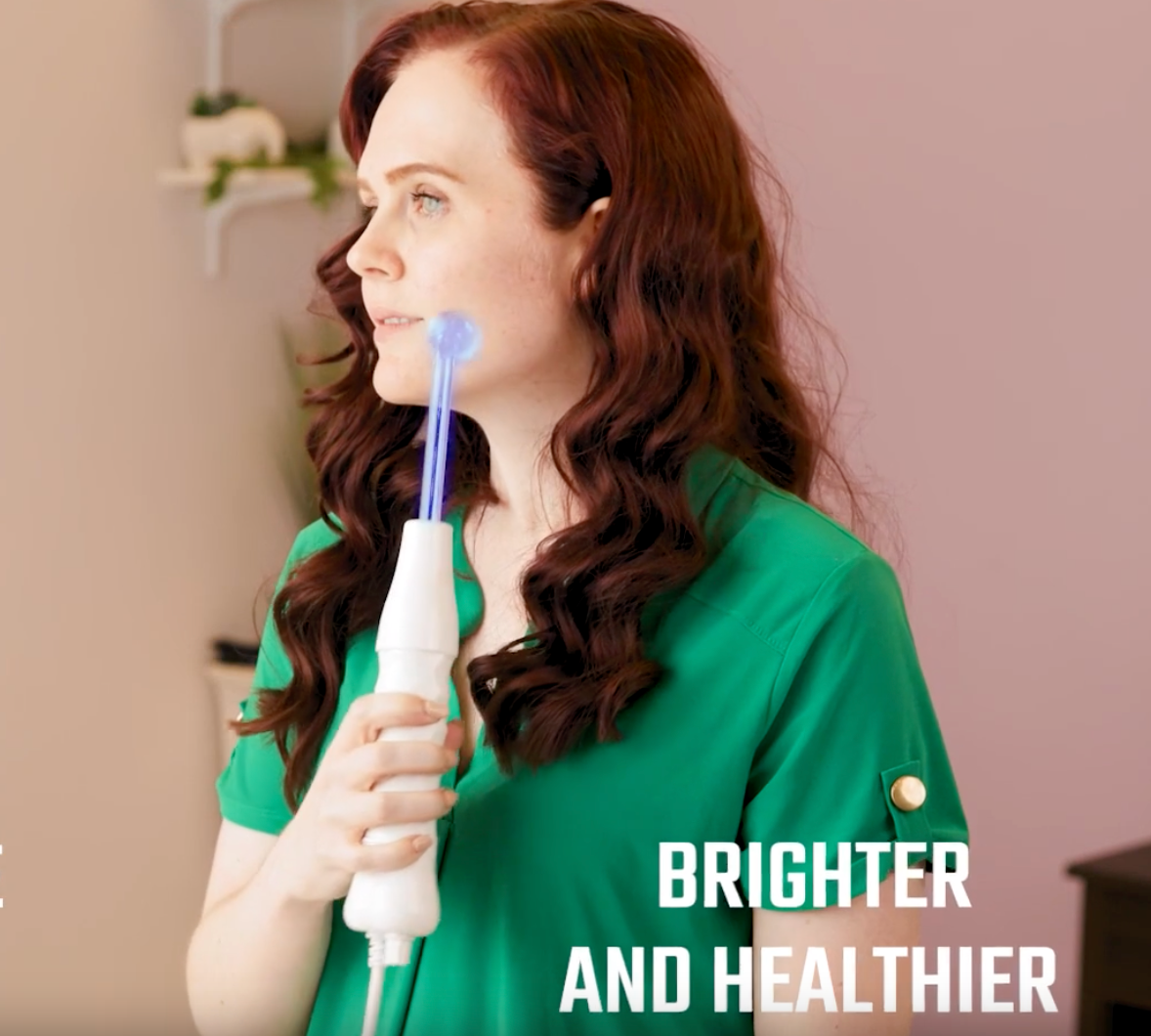 woman uses high frequency device for brighter healthier skin